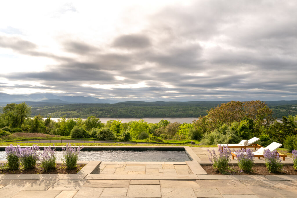Scenic poolside view with mountains.