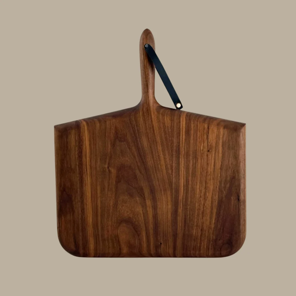 Walnut cutting and serving board with a leather strap from KHEM Studios